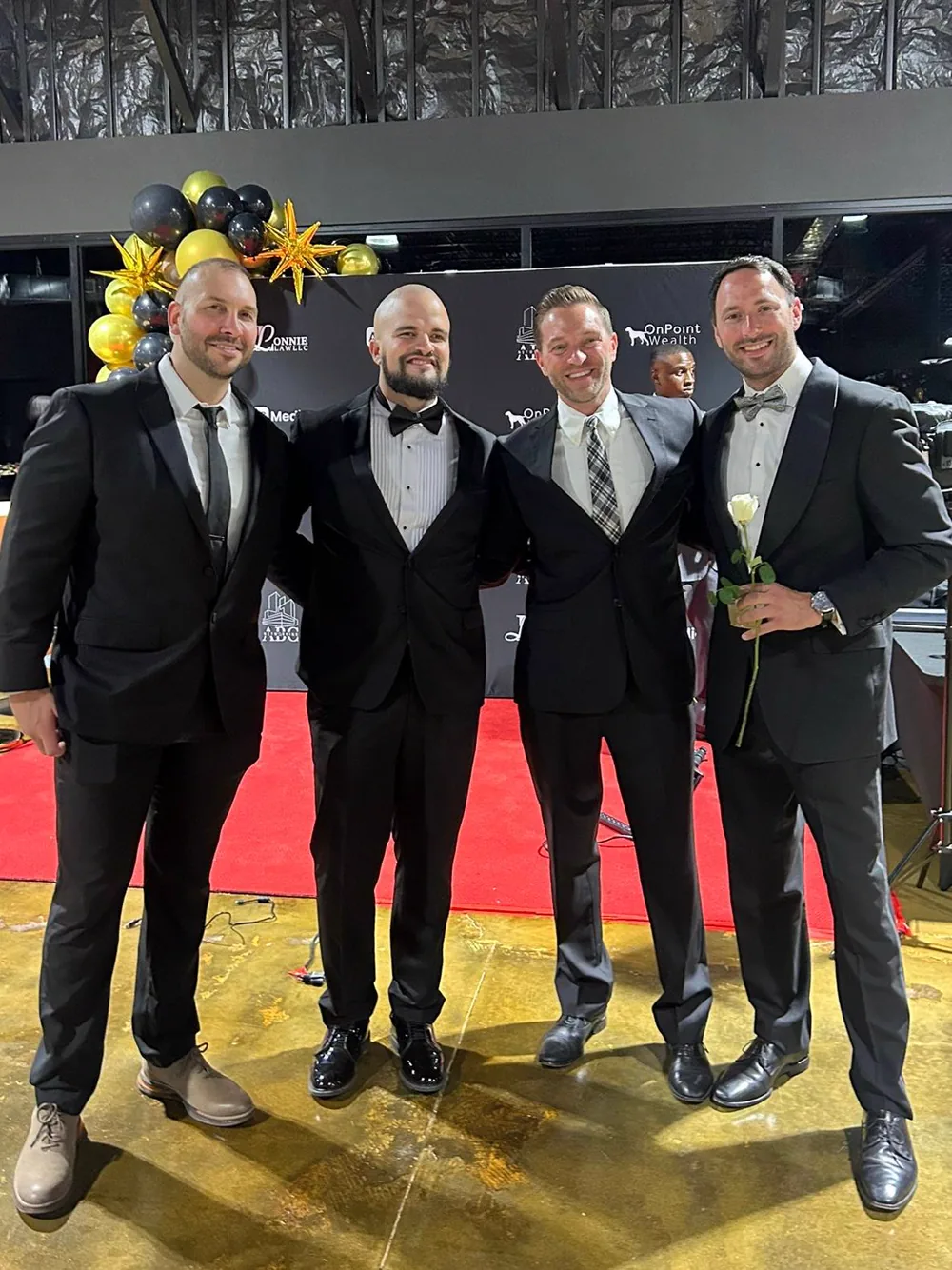 Four formally dressed business guests at the 2025 gala